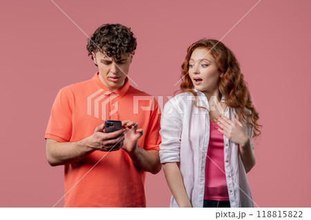 Suspicious Woman Spying On Boyfriend Chats With Smartphone. Jealousy, Curiosity Suspicious Woman Spying On Boyfriend Chats With Smartphone. Jealousy, Curiosity 118815822