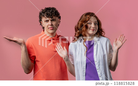 Confused man woman, couple shoulders up - can't help, makes gesture of dont know 118815828