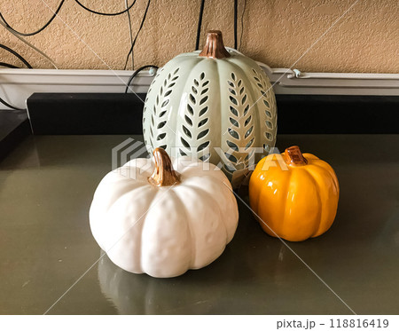 Still life of decorative pumpkins on the table. Reflection. Pumpkin candlestick. Halloween Still life of decorative pumpkins on the table. Reflection. Pumpkin candlestick. Halloween 118816419