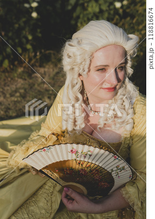 Portrait of blonde woman dressed in historical Baroque clothes with old fashion hairstyle Portrait of blonde woman dressed in historical Baroque clothes with old fashion hairstyle 118816674