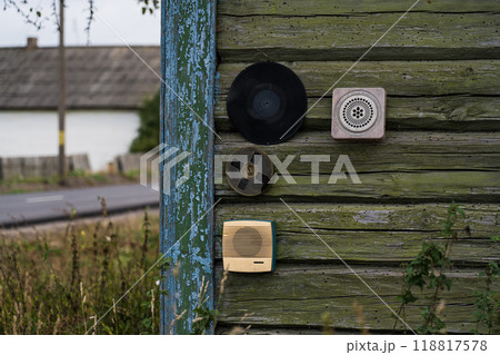 All sorts of junk hangs on the wall of a wooden, rustic house All sorts of junk hangs on the wall of a wooden, rustic house 118817578