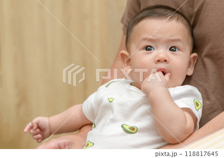 Asian infant baby open mouth and putting fingers in to sucking feel secure. Asian infant baby open mouth and putting fingers in to sucking feel secure. 118817645