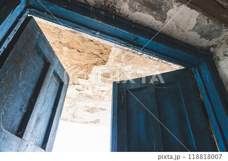 The open, blue doors of the main entrance, to an abandoned, rustic store 118818007