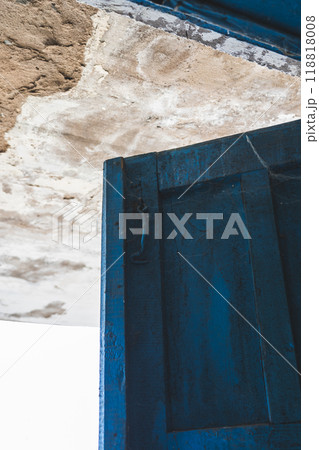 The open, blue doors of the main entrance, to an abandoned, rustic store The open, blue doors of the main entrance, to an abandoned, rustic store 118818008