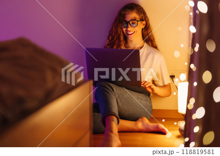 Woman working online on laptop computer at home. Business, blogging, freelance, education concept. Woman working online on laptop computer at home. Business, blogging, freelance, education concept. 118819581