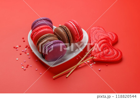 Various colorful macaroons in heart shaped bowl 118820544