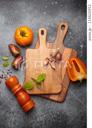 Fresh cooking ingredients lying on rustic kitchen countertop with cutting boards top view Fresh cooking ingredients lying on rustic kitchen countertop with cutting boards top view 118820952