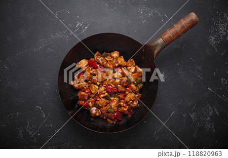 Traditional Chinese dish kung pao chicken in wok pan on dark background top view 118820963