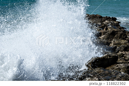 Close-up of sea waves breaking on the rocks of Vilanova y la Geltru beach	 118822302