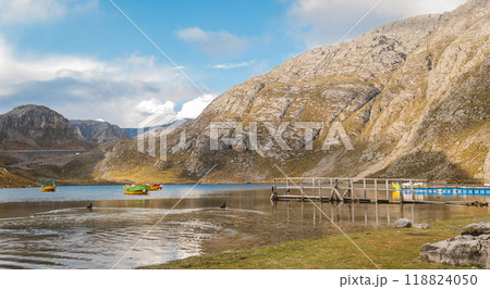A lake with a dock and a few boats in lagoon seven colors, Road to the Mountain range of the Viuda, Canta. Peru. A lake with a dock and a few boats in lagoon seven colors, Road to the Mountain range of the Viuda, Canta. Peru. 118824050