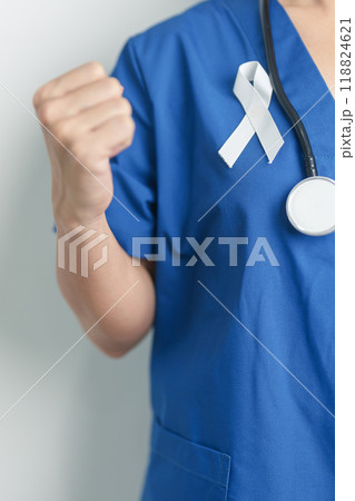 November Lung Cancer Awareness month and Stop Violence Against Women. Doctor with White ribbon in hospital. Healthcare and World Cancer day concept 118824621