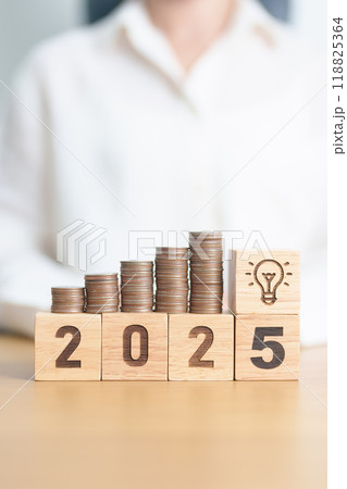 Happy New Year 2025 with Coins stack and lightbulb icon. Business Idea, Creative, Thinking, brainstorm,Money, Budget, investment, financial, savings and New Year Resolution concept 118825364