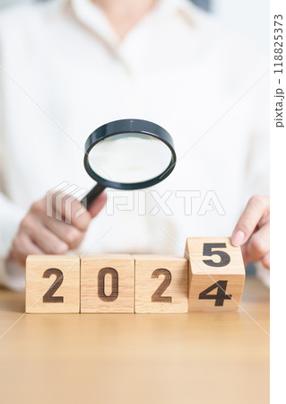 2024 end year to Happy New Year 2025 with magnifying glass and people. hiring, employee, recruitment, job, SEO and jobless concept 118825373