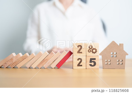 2025 year with wood block falling to Home model and business icon. Real estate Mortgage, Refinance, House loan and debt, Interest rate, Insurance, Financial Property and economic recession 2025 year with wood block falling to Home model and business icon. Real estate Mortgage, Refinance, House loan and debt, Interest rate, Insurance, Financial Property and economic recession 118825608