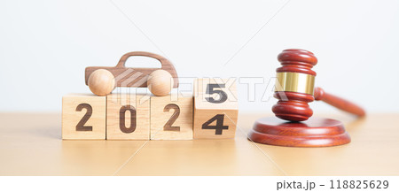 2024 end year to Happy New Year 2025 with small toy car models and Judges gavel on desk in courthouse. Car Law, Insurance, auto Tax, Auction and Bidding concepts 118825629