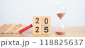 wood block falling to 2025 year with hour glass or sandglass. risk management, financial, deflation and Inflation, Insurance and economic recession concepts 118825637