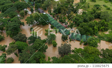 Aerial view of local house in suburb area of Chiang Rai province flooding by Kok river after typhoon Yagi has swept Southeast Asia. Aerial view of local house in suburb area of Chiang Rai province flooding by Kok river after typhoon Yagi has swept Southeast Asia. 118825675