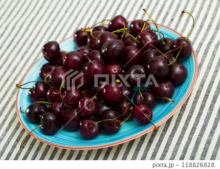 Closeup of fresh tasty red berries cherry on plate 118826828