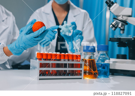 Scientist using microscope in laboratory. Close-up of a researcher's hands adjusting a modern microscope in a lab setting. Science concept Scientist using microscope in laboratory. Close-up of a researcher's hands adjusting a modern microscope in a lab setting. Science concept 118827091