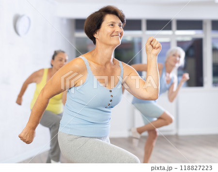 Three elderly women are learning sports Latin American dances in studio class 118827223