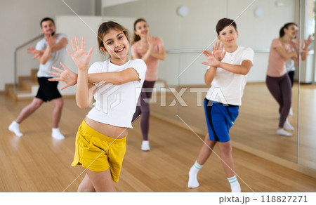 Girl exercising during family dance class Girl exercising during family dance class 118827271