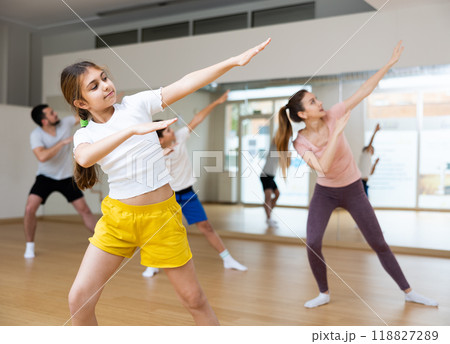 Girl exercising during family dance class Girl exercising during family dance class 118827289