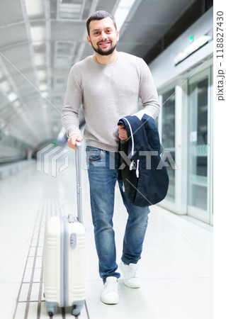 Portrait of confident male passenger in casual clothing on underground platform 118827430