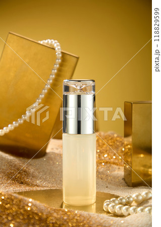 The photography of luxury theme was shot from close up front view. Unbranded cosmetic bottle displayed in center, gold and jewelry decorated in back. Blank space for design and adding text 118829599