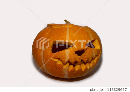 A Spooky Halloween Pumpkin featuring a Scary Face Carving that instills a sense of fear A Spooky Halloween Pumpkin featuring a Scary Face Carving that instills a sense of fear 118829687