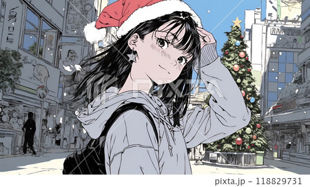 ホワイトクリスマスの街を歩く若い女性