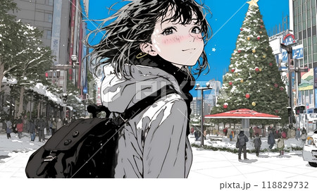 ホワイトクリスマスの街を歩く若い女性