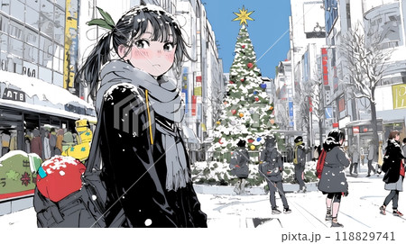 ホワイトクリスマスの街を歩く若い女性