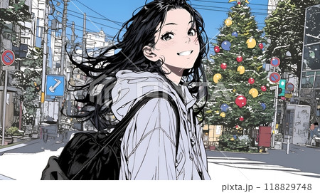 ホワイトクリスマスの街を歩く若い女性