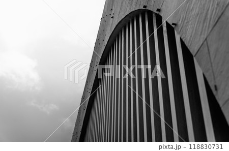 A structure featuring wooden slats on construction site contributing to its architectural style. 118830731
