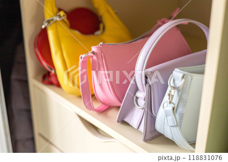 Comfortable women's dressing room with stylish multi-colored and fashionable bags.  118831076