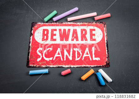 SCANDAL. Beware sign with text and colored pieces of chalk on a dark chalkboard background SCANDAL. Beware sign with text and colored pieces of chalk on a dark chalkboard background 118831682