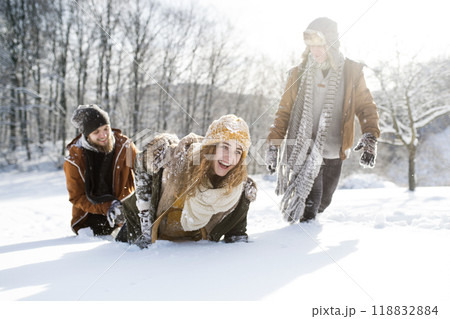 Friends in snowball fight in snowy nature. First snowfall of the season. 118832884