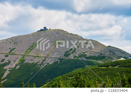 Panoramic view of winding mountain trail leading to summit of Sniezka and hiker tourists on path in Karpacz, Poland. Travel tourism and hiking concept 118833404