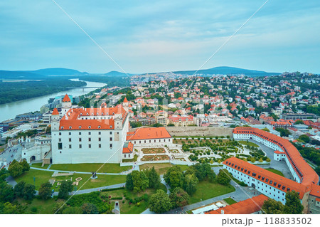 Panorama of Bratislava, Slovakia. Aerial view of historic European city with vibrant red rooftops. Urban landscape with historical buildings Panorama of Bratislava, Slovakia. Aerial view of historic European city with vibrant red rooftops. Urban landscape with historical buildings 118833502