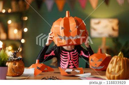 girl with polygonal paper pumpkin 118833920
