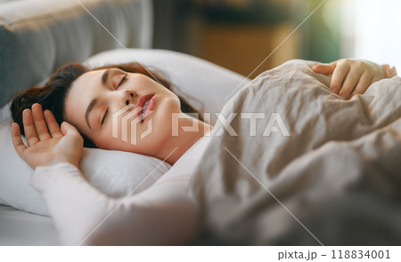 woman is sleeping in the bedroom 118834001