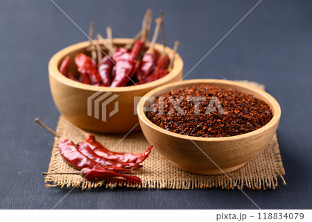 Red chili powder in bowl on black background, Food ingredient 118834079