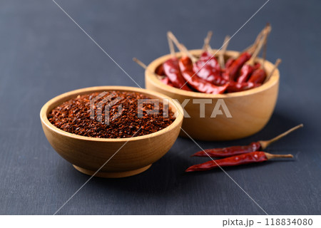 Red chili powder in bowl on black background, Food ingredient 118834080