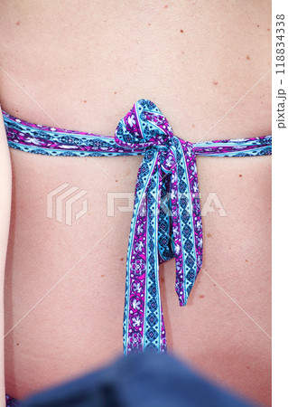 knot of bikini on a woman 118834338