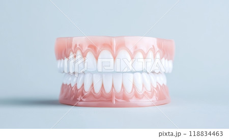 Full set of artificial teeth perfectly aligned, demonstrating dental health and t precision of modern prosthesis. 118834463