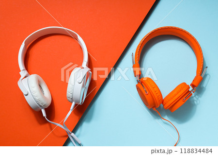 A pair of over-the-ear headphones on a light background. A pair of over-the-ear headphones on a light background. 118834484