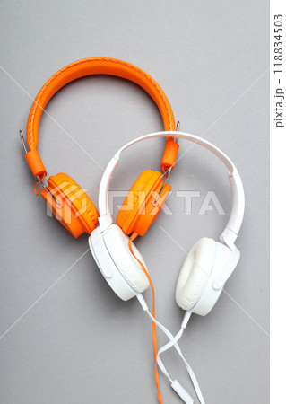 A pair of over-the-ear headphones on a light background. A pair of over-the-ear headphones on a light background. 118834503