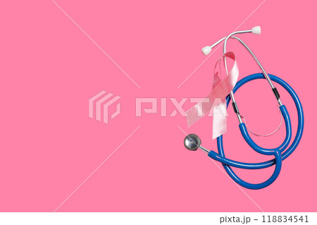 Stethoscope with pink ribbon on pink background 118834541