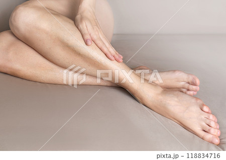 Woman shows her hairy legs. Body positive, naturalness 118834716