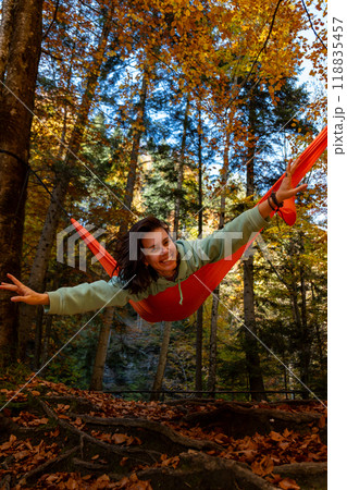 Relaxing in a Hammock in Autumn Forest Relaxing in a Hammock in Autumn Forest 118835457
